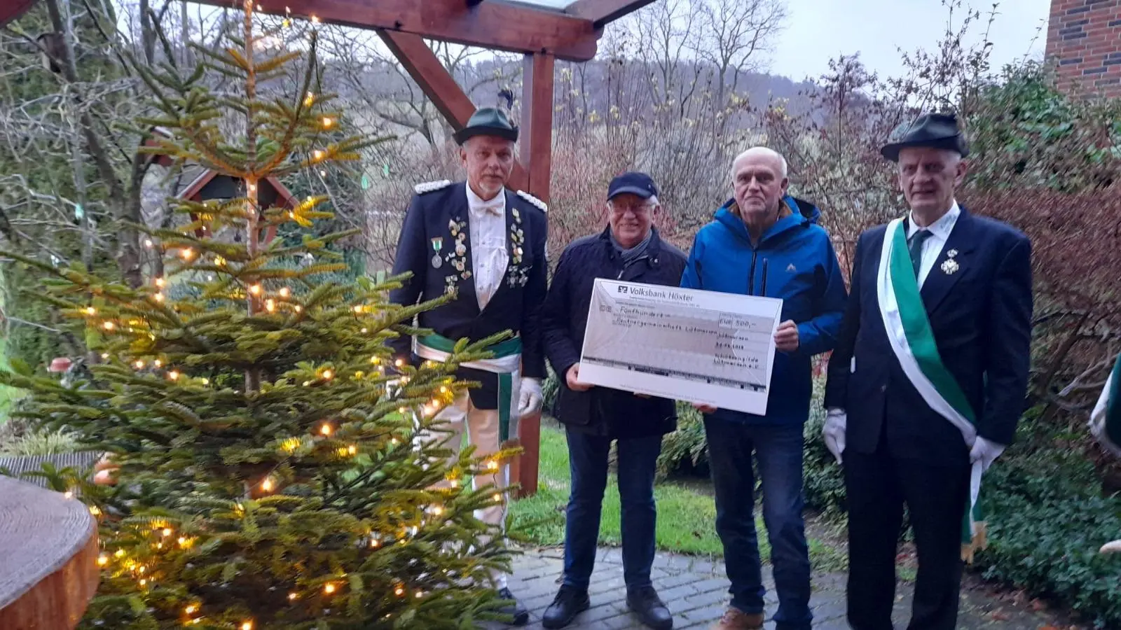 Der erste Vorsitzende/Kommissar Thomas Rust (rechts) und (v.l.) Oberst Uwe Thielsch von der Schützengilde Lütmarsen e.V überreichen den Spendencheck an Johannes Mönnekes und Ulrich Müller von der Arbeitsgemeinschaft „schönes Lütmarsen”. (Foto: privat)