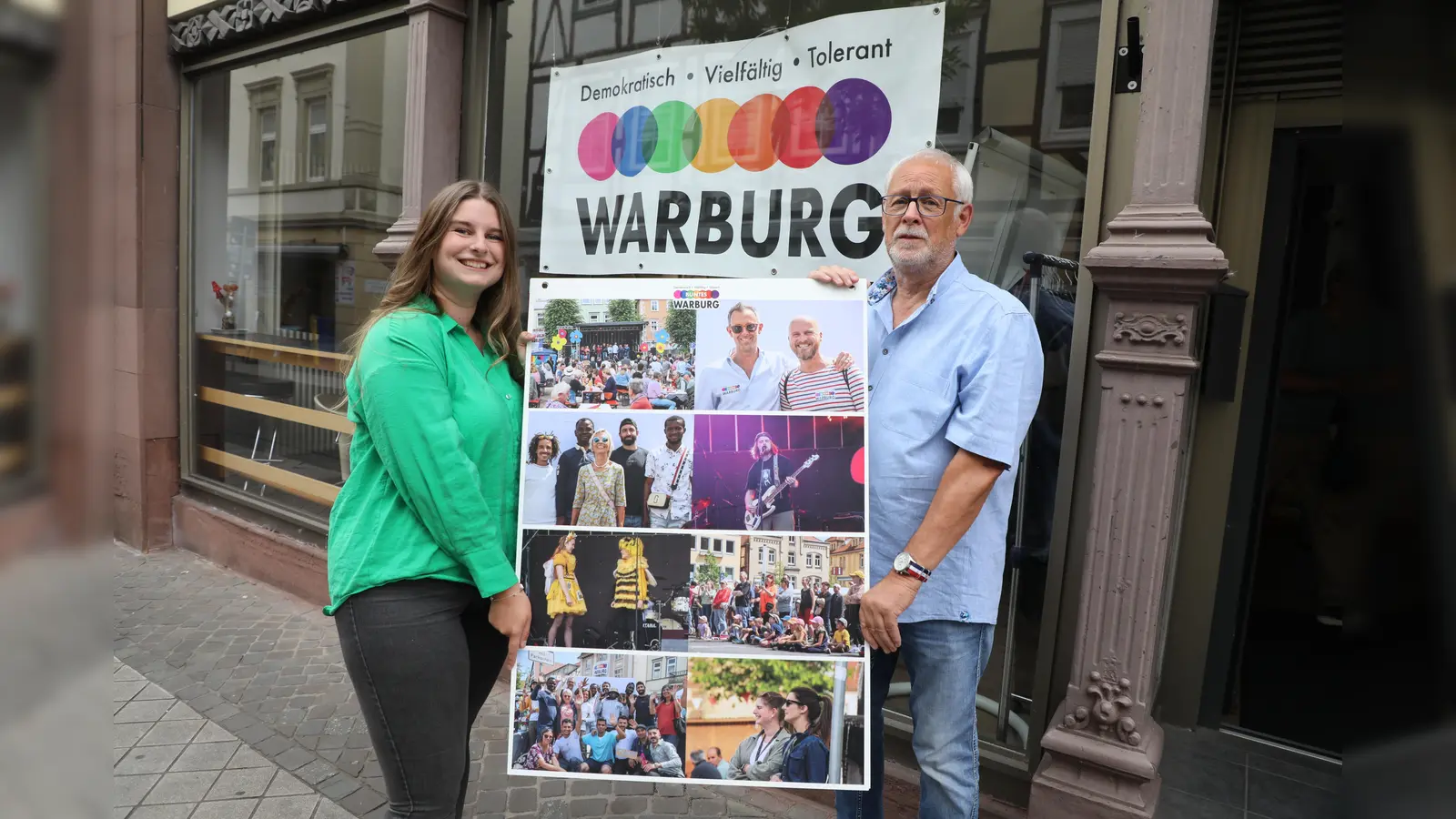 Johanna Wiesendahl und Karl-Heinz Wiemers mit einer der vier Fototafeln mit Eindrücken vom Bunten Fest in Warburg, die in den Schaufenstern der Zweiten Heimat an der Hauptstraße in Warburg zu sehen sind.<br> (Foto: Buntes Warburg)